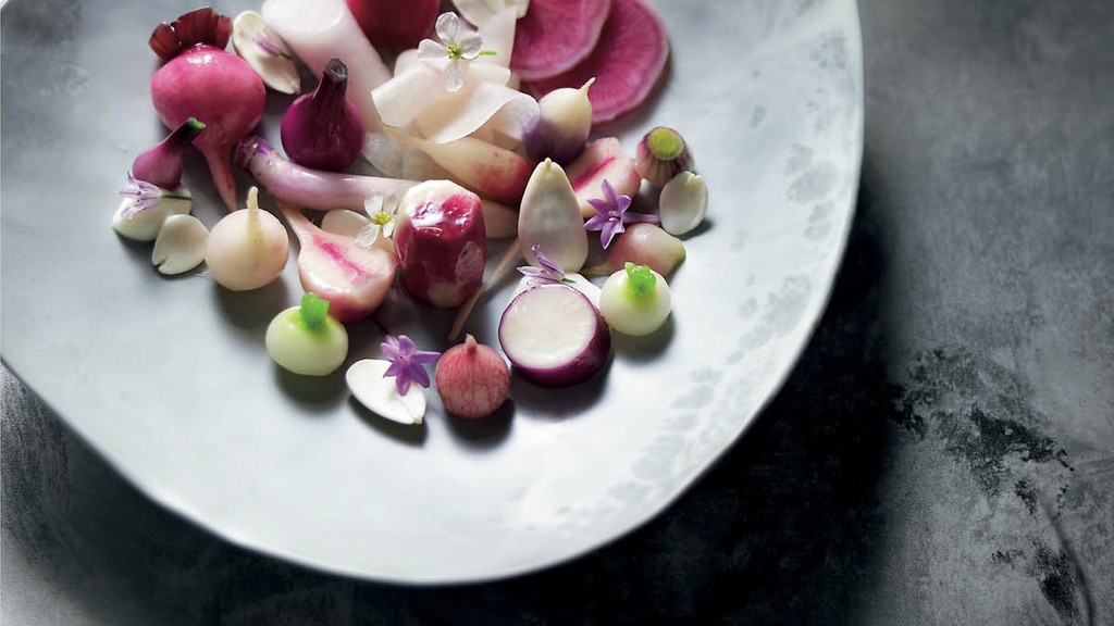 A 2 part image showing peeled turnips being sliced on a mandoline